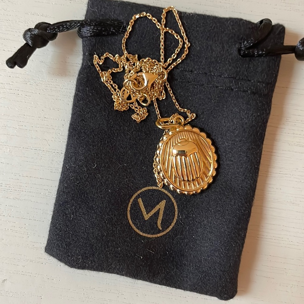 Mejuri resilience scarab coin pendent.
